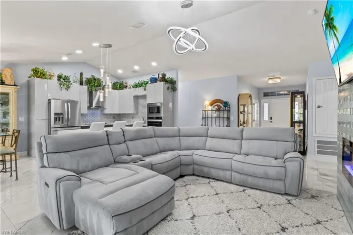 Enjoy an unobstructed view of the sleek kitchen and elegant living room, designed for both everyday comfort and entertaining