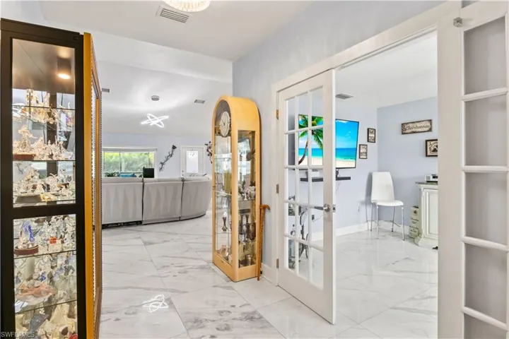 Enter into an airy foyer where natural light and tasteful details create a warm and welcoming atmosphere.