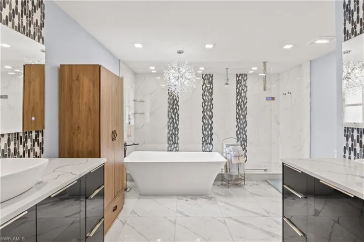 Indulge in spa-style comfort with dual sinks, a freestanding tub, and a walk-in shower designed for pure relaxation.