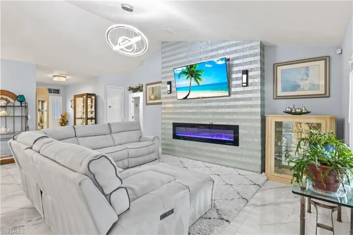 Bright and stylish with sleek tile flooring and a stunning fireplace that adds warmth and wow factor to this modern living space.
