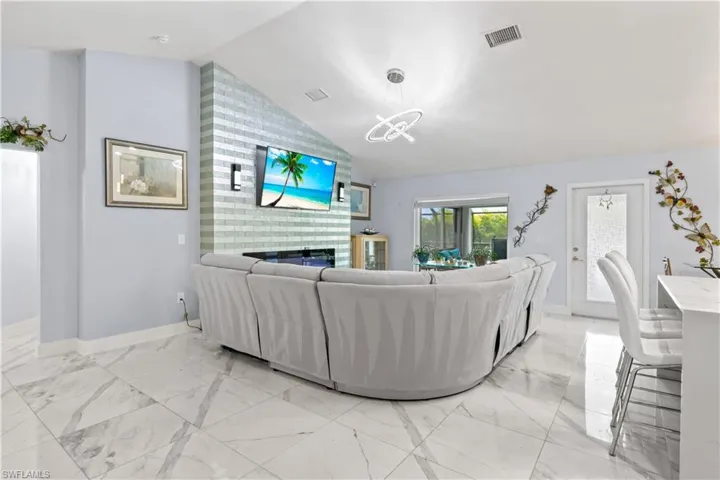 Bright, open, and centered around a stunning designer fireplace—perfect for relaxing or entertaining.
