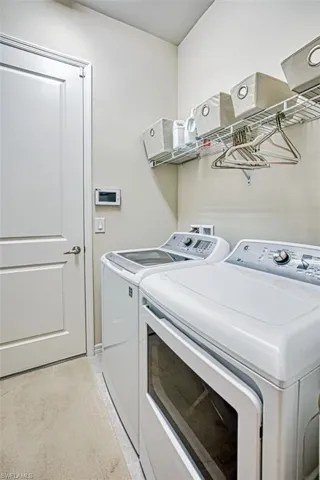 Clothes washing area featuring independent washer and dryer