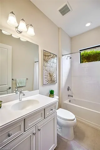Full bathroom featuring tile patterned floors, vanity, shower / tub combo, and toilet