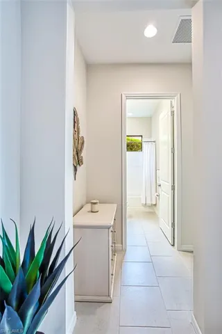 Corridor featuring light tile patterned floors