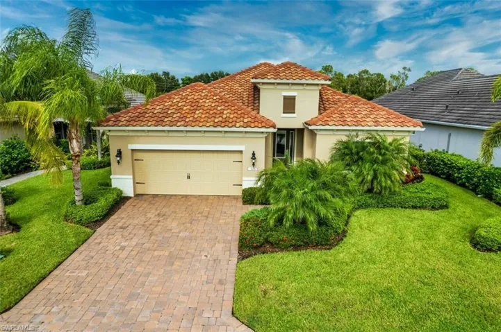 Mediterranean / spanish-style home featuring a garage and a front yard