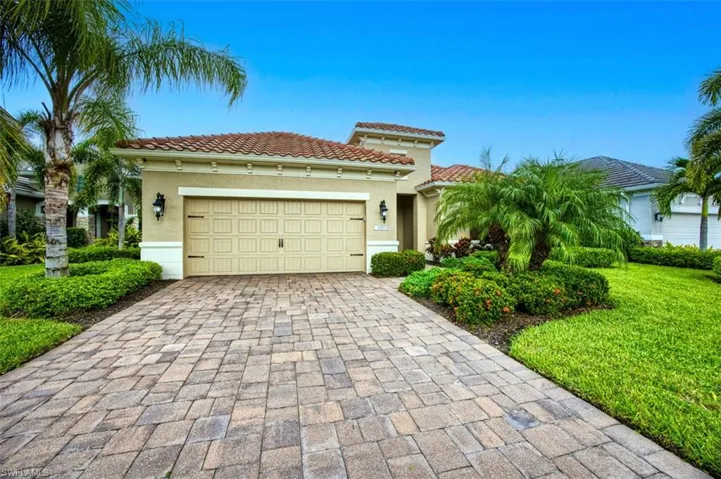 View of front of home featuring a garage and a front yard