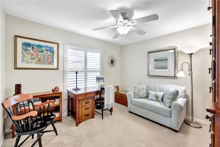 Carpeted office space with ceiling fan