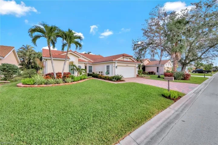 Mediterranean / spanish-style house featuring a garage and a front yard