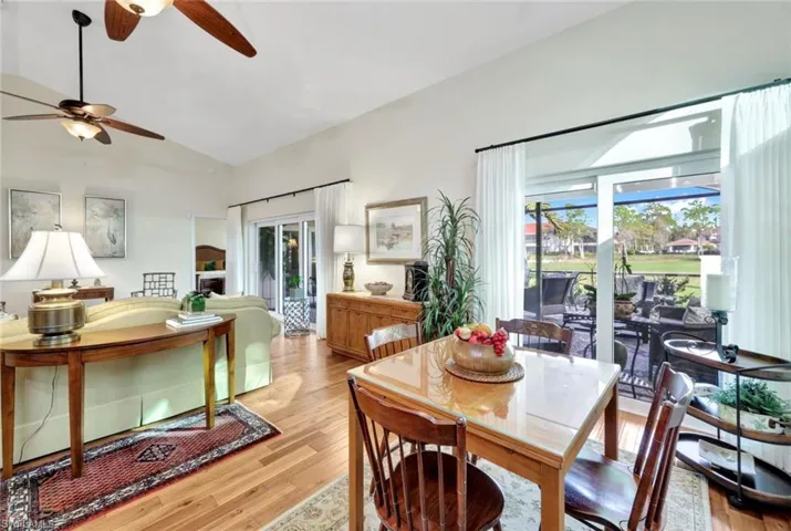 Dining space with lofted ceiling and light wood-type flooring
