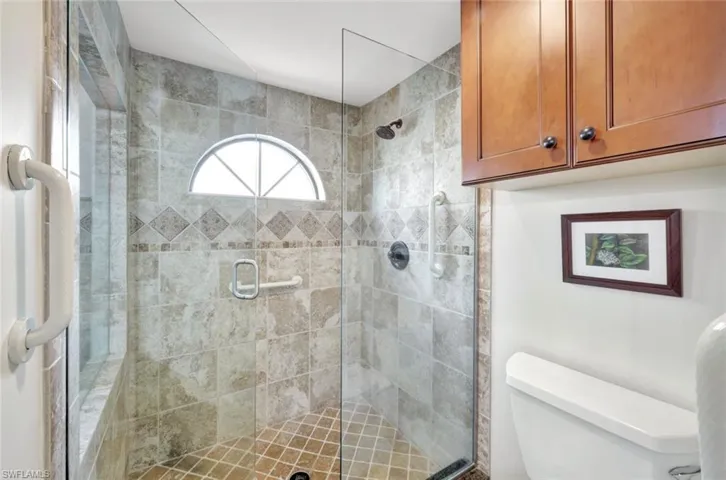 Bathroom featuring toilet and an enclosed shower