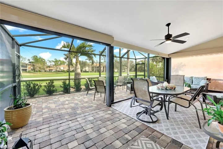 Sunroom with ceiling fan and vaulted ceiling