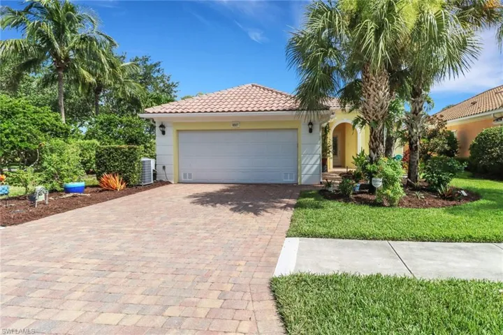 Mediterranean / Florida home featuring a garage, decorative driveway, stucco siding, and a tile roof