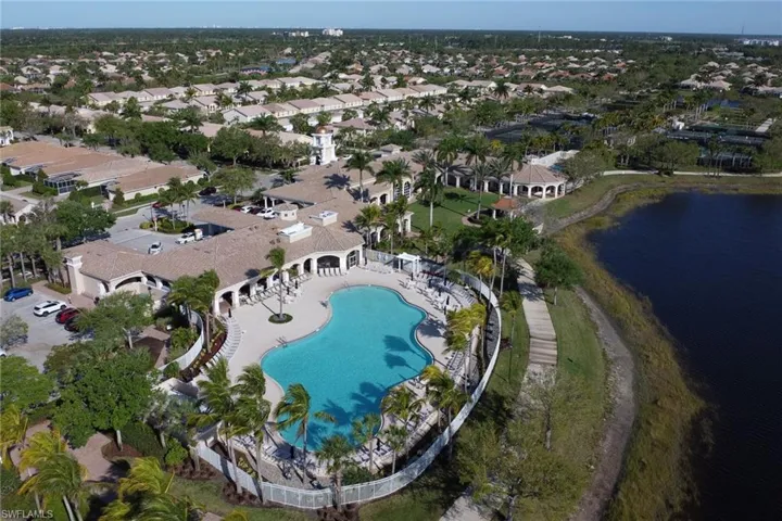 Drone / aerial view of a pool area and a large body of water