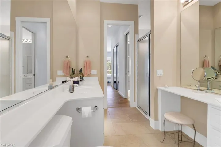 Bathroom featuring a shower stall, vanity, and tile patterned floors