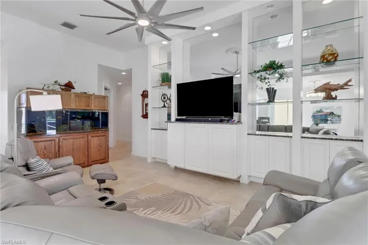 Living area with ceiling fan and recessed lighting