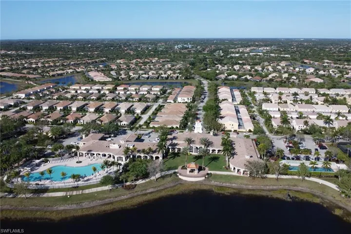 Aerial view of property's location with a large body of water and nearby suburban area
