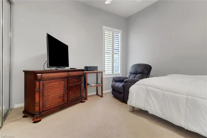 Bedroom featuring light colored carpet and ceiling fan