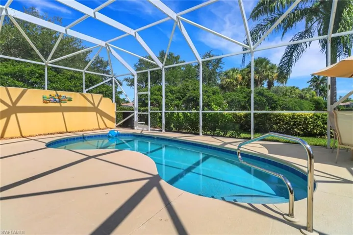 Swimming pool with a patio area and glass enclosure