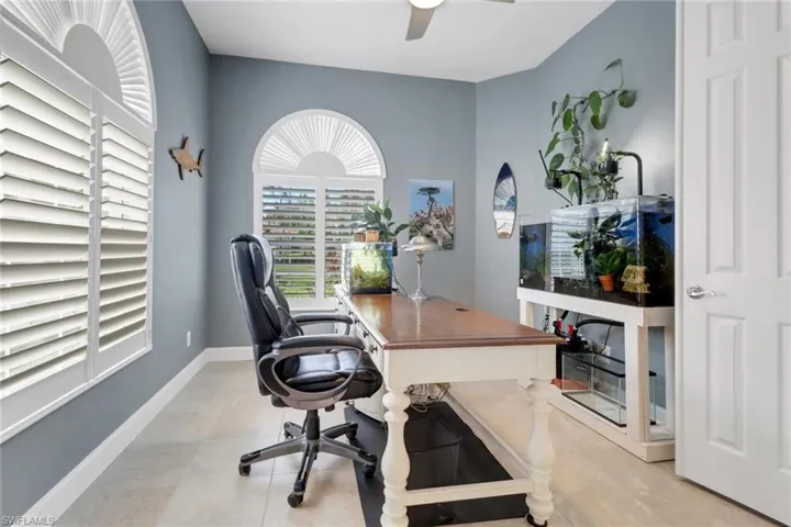 Office space featuring baseboards and a ceiling fan