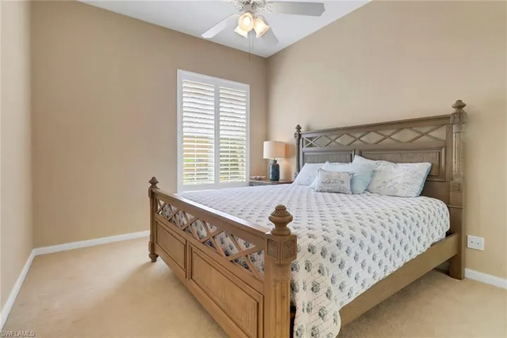 Bedroom featuring light colored carpet and ceiling fan