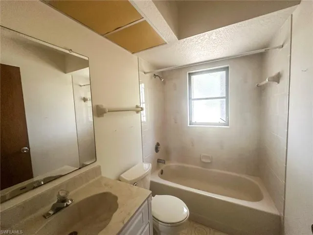 Hallway bathroom with tub