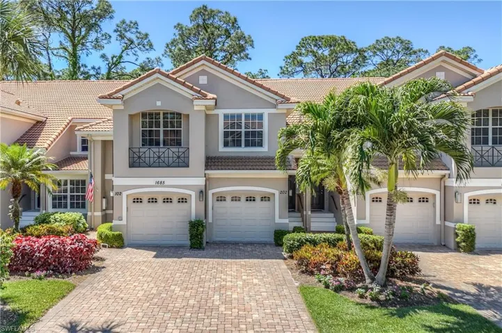 Mediterranean / spanish-style home with a tiled roof, decorative driveway, and stucco siding