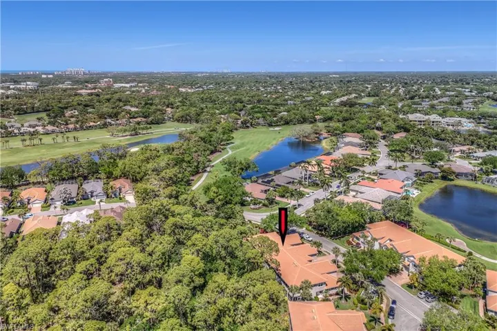 Aerial view with a residential view, golf course view, and a water view