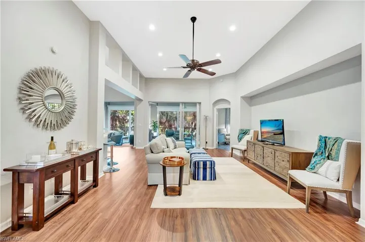 Living room featuring light wood-style flooring, recessed lighting, a ceiling fan, and baseboards