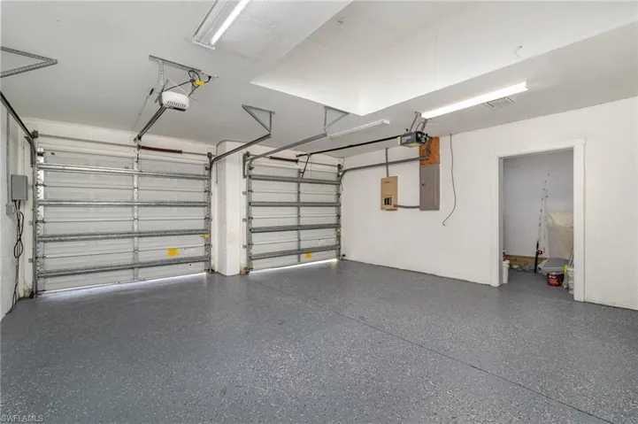 Two Car Garage featuring electric panel and a garage door opener
