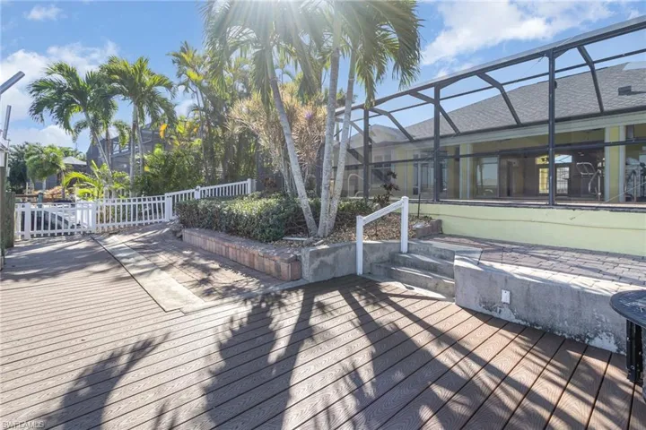 Wooden deck featuring glass enclosure