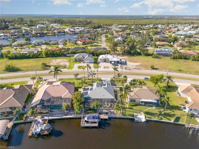 Birds eye view of property with a water view