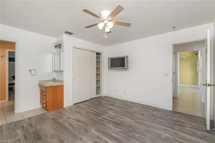 bedroom 3 featuring closet, light hardwood / wood-style floors, and sink