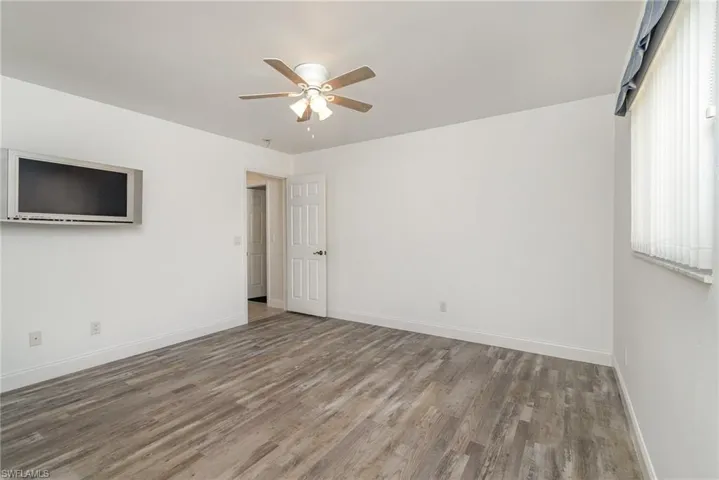 Bedroom 3 with hardwood / wood-style flooring and ceiling fan