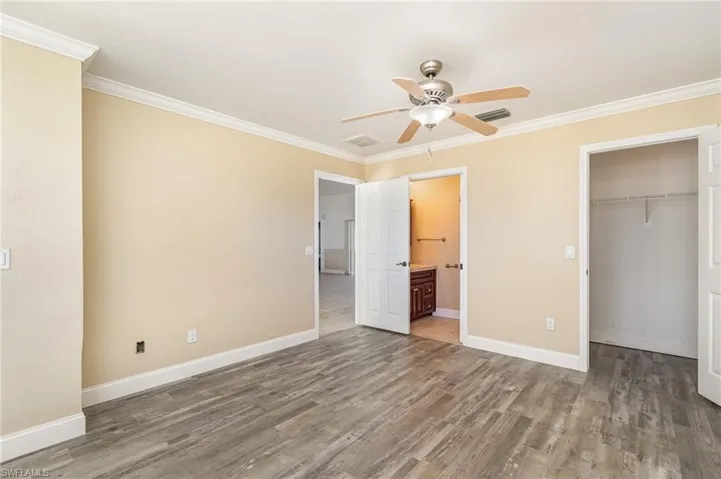 bedroom 4 / Den featuring 1/2 Bath, Engineered wood-style flooring, ornamental molding, and  closet