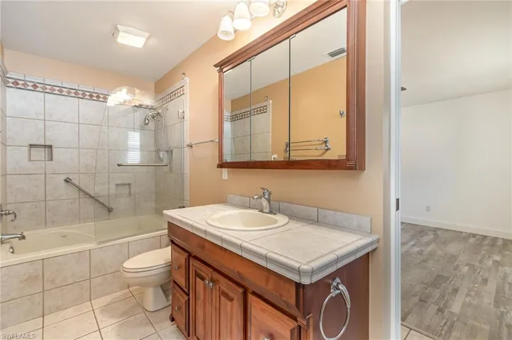bathroom 2 connects bedrooms 2 & 3, features toilet, vanity, tiled shower / bath combo,