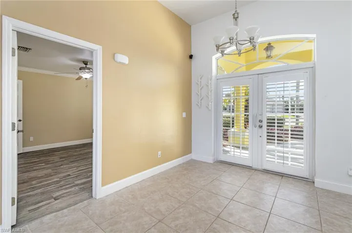Front double door and access to bedroom 4/ den
