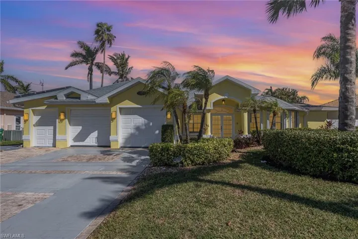 Single story home featuring a yard and a garage