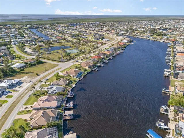 Birds eye view of property with a water view