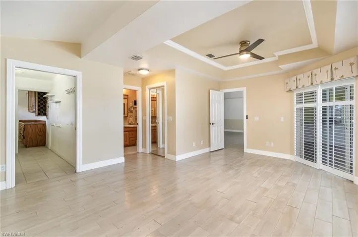 Master bedroom with access to laundry, two closets, bathroom and slider to pool deck