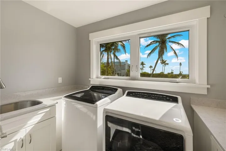 Laundry room with cabinet space and washing machine and clothes dryer