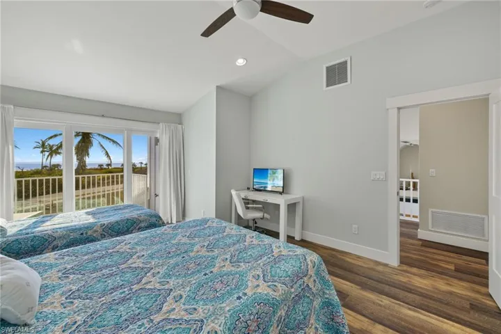 Bedroom with lofted ceiling, access to exterior, dark wood-style flooring, recessed lighting, and ceiling fan
