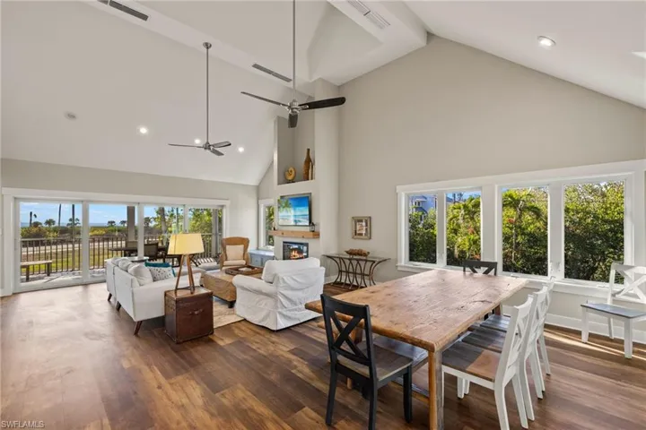 Dining room with high vaulted ceiling, recessed lighting, and dark wood finished floors