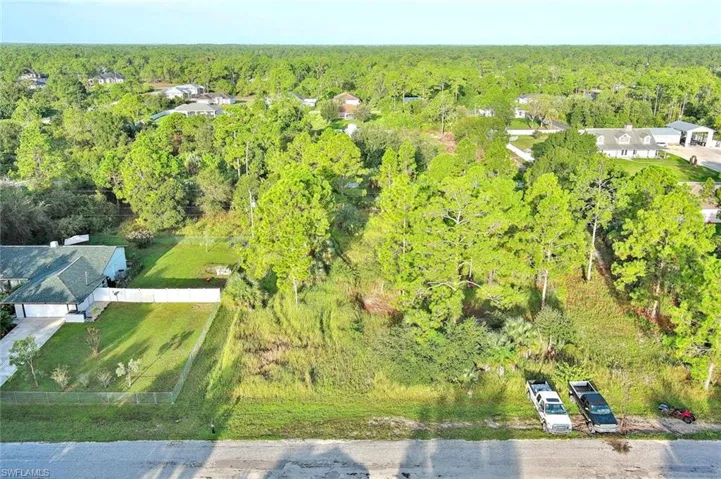 View of subject property with a heavily wooded area