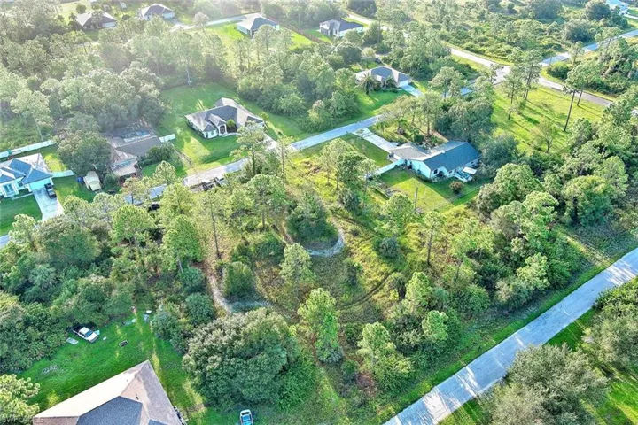 Aerial overview of property's location with a tree filled landscape