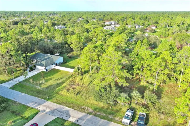 Aerial view of property's location with a forest