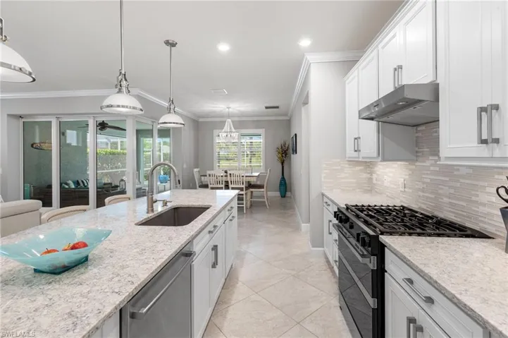 Kitchen w/Quartz counters, upgraded backsplash and under cabinet lighting