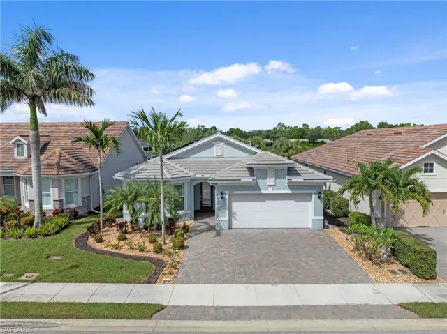 Aerial view of front of home, notice custom landscaping, expanded driveway