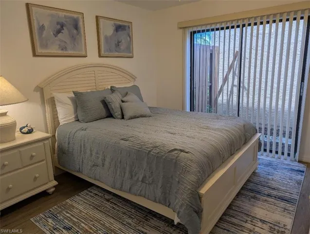 Bedroom with dark wood-type flooring