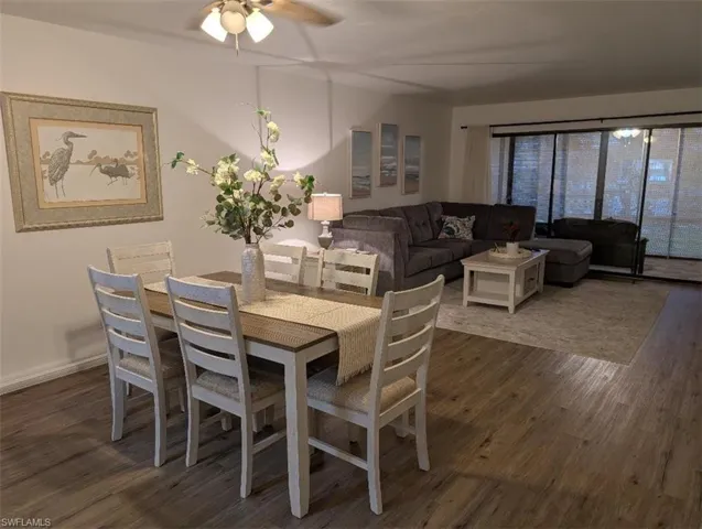 Dining room featuring dark wood-style floors and ceiling fan