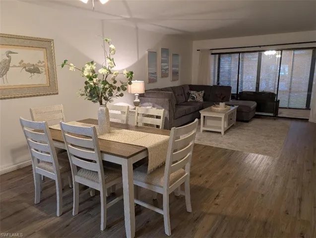 Dining area with dark wood-type flooring